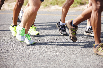 Buy stock photo Shot of the legs of a group of men running a road race