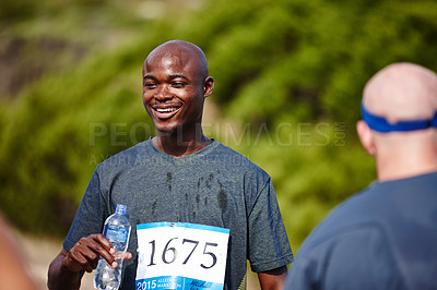Buy stock photo Shot of a young male runner drinking water after a race
