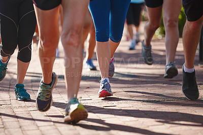 Buy stock photo Cropped shot of a group of people running