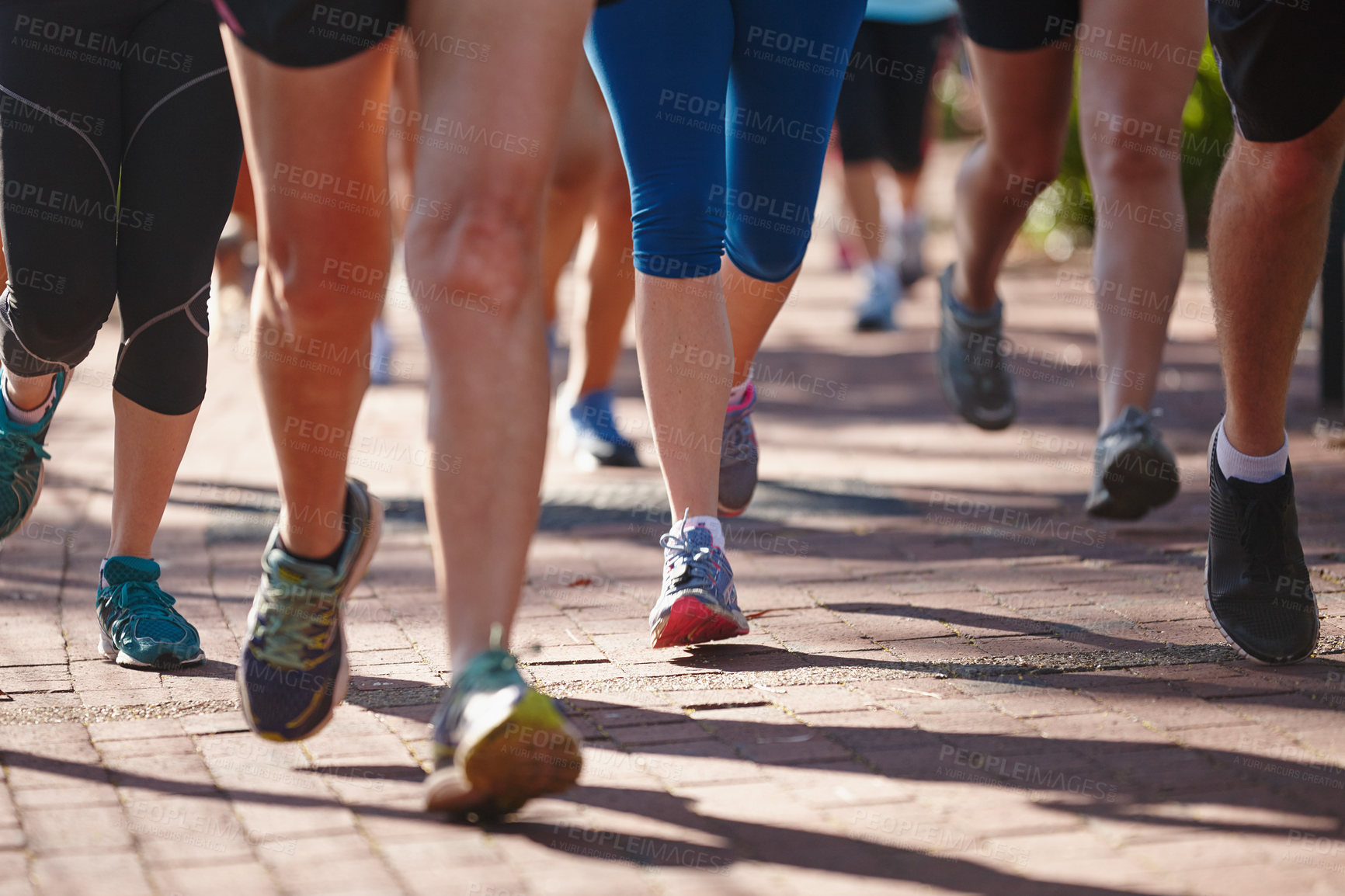 Buy stock photo Cropped shot of a group of people running