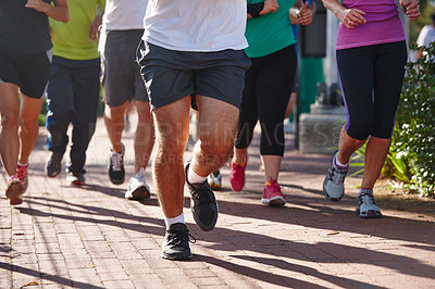 Buy stock photo Cropped shot of a group of people running