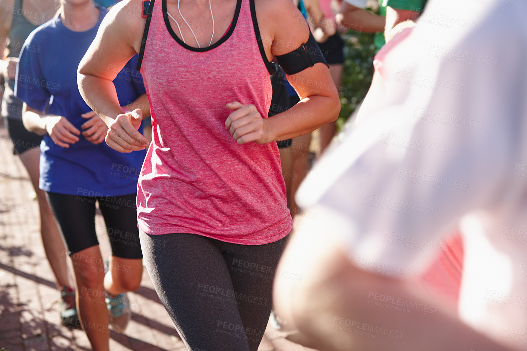 Buy stock photo Cropped shot of a group of people running