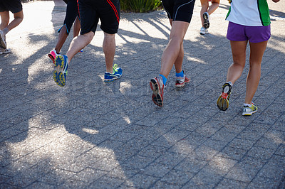 Buy stock photo Cropped shot of a group of people running