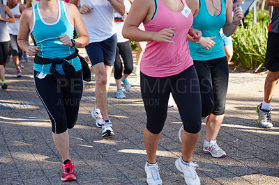 Buy stock photo Cropped shot of a group of people running