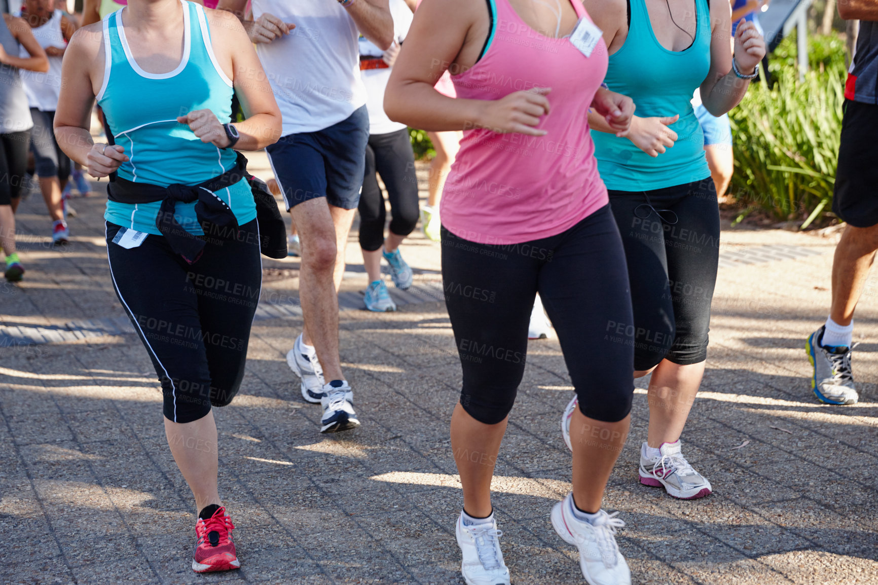 Buy stock photo Cropped shot of a group of people running