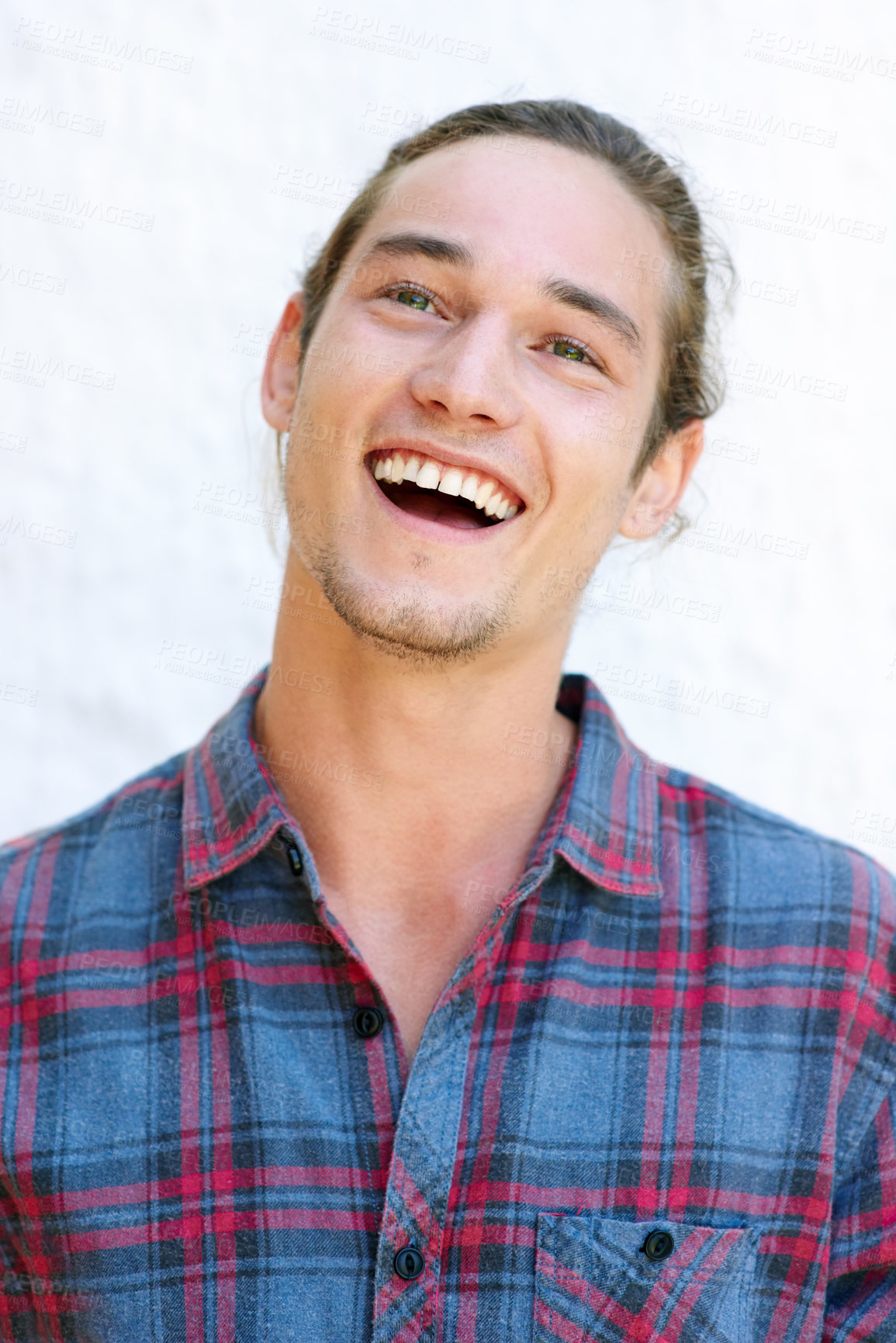 Buy stock photo Laughing, portrait and man with fashion, smile and trendy for guy, confident and happy with outfit. Wall, cool and person with checkered shirt, clothes and joy with casual aesthetic in Canada