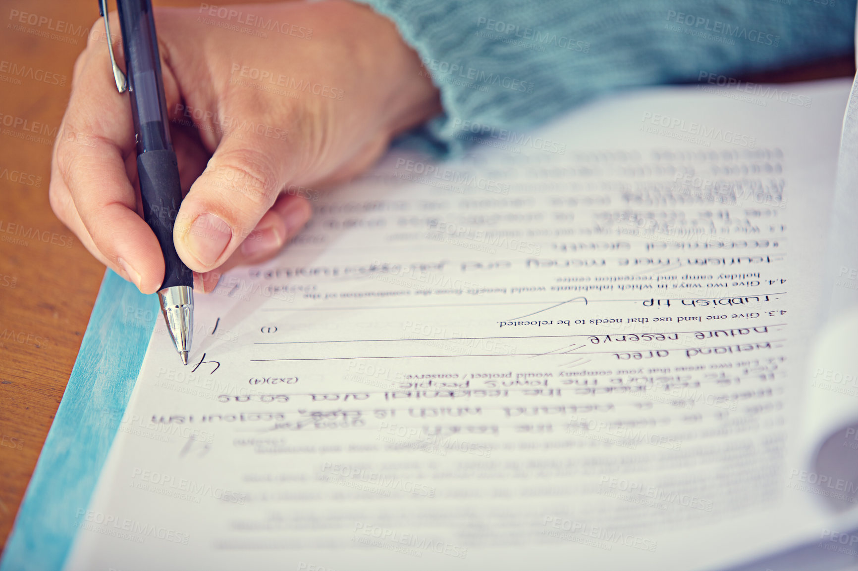 Buy stock photo Test, quiz and hand of teacher on paper grading and writing on desk with pen for education. Exam, closeup and person on table working with questions, answer and results of student assessment