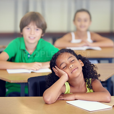 Buy stock photo A little girl daydreaming during a school lesson