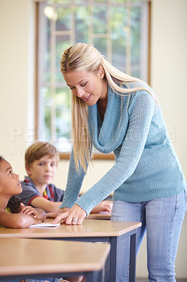Buy stock photo Teacher, kids and students in classroom for education, learning and writing or language development with support. Happy woman and children for teaching, helping with knowledge and questions at school