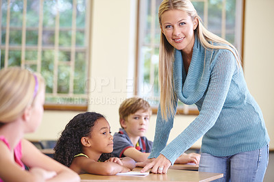 Buy stock photo Portrait, woman and smile of teacher in class helping students in classroom. Teaching, female educator and happy person with children learning in primary school for education, studying or knowledge.