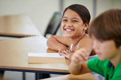 Buy stock photo Portrait, children and girl in a classroom, education and relax with a book, learning and creative. Face, studying or students with joy, child development or desk with notes and knowledge in school