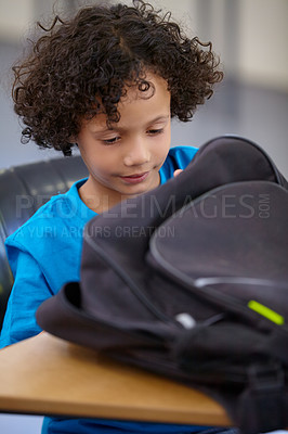 Buy stock photo Boy, education and school bag with thinking, child development and searching with learning, study and table. Kid, classroom or student with a backpack, desk and confident with information and excited