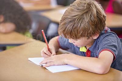 Buy stock photo School, boy and writing in book in classroom, desk and studying for education, knowledge and learning assessment. Child, kid and student drawing in notebook for academic development, test and lesson