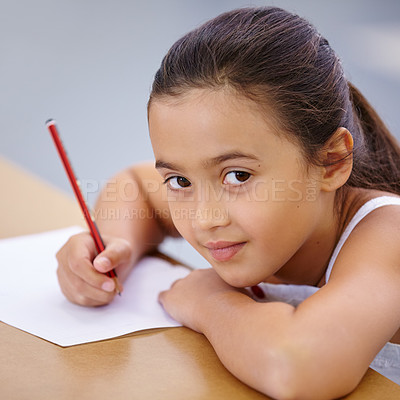 Buy stock photo Child, portrait and education of student taking notes in classroom for knowledge and development. Serious, girl and learner writing on paper, studying or learning in middle school class in Spain.