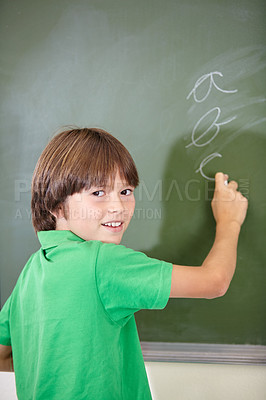 Buy stock photo Portrait, knowledge and boy drawing on a chalkboard for child development, creativity and art for learning. Academic, face and kid student writing with information in the classroom and answers