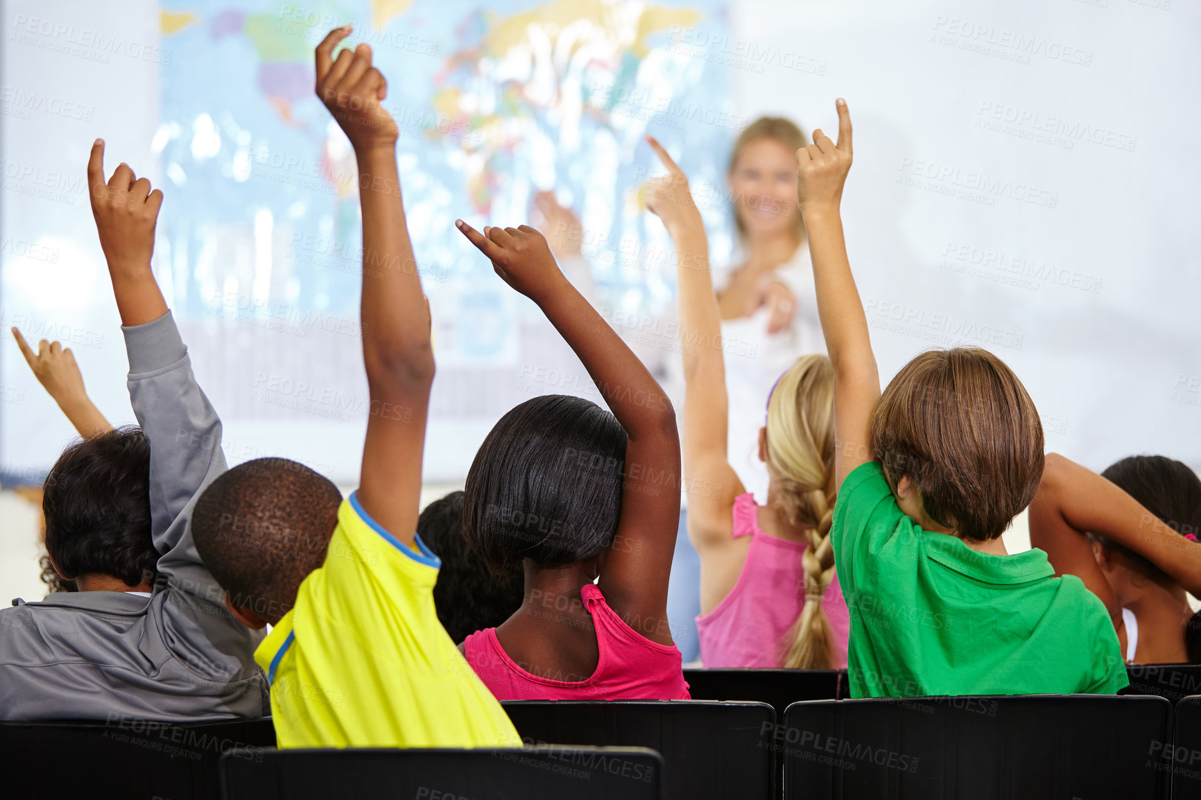 Buy stock photo Back of children, teacher and raise hands for questions, education or learning with geography quiz in classroom. Youth, group of students and school for teaching support, map ideas and answer or yes