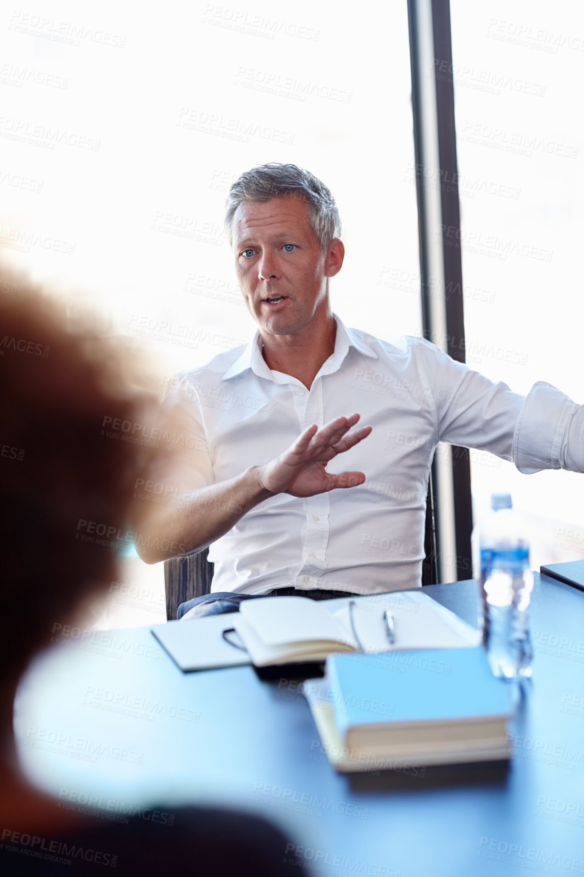 Buy stock photo Shot of two colleagues having a discussion in the office