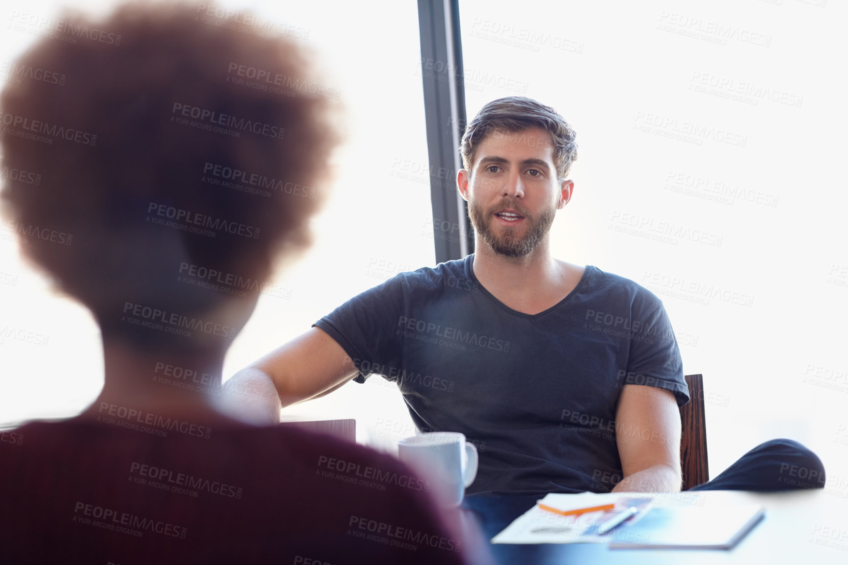 Buy stock photo Shot of two colleagues having a discussion in the office