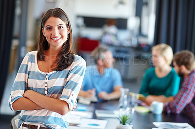 Buy stock photo Portrait of a beautiful woman with her colleagues blurred in the background
