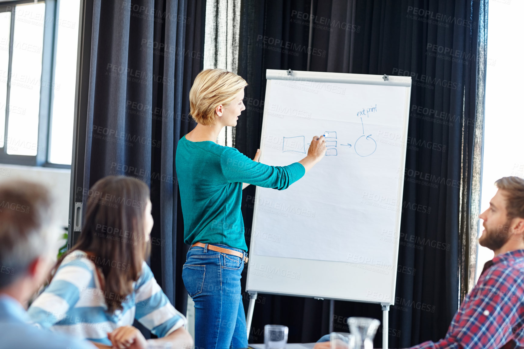 Buy stock photo Shot of an attractive woman doing a presentation for her colleagues