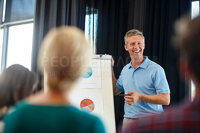 Buy stock photo Shot of a mature man doing a presentation for his colleagues