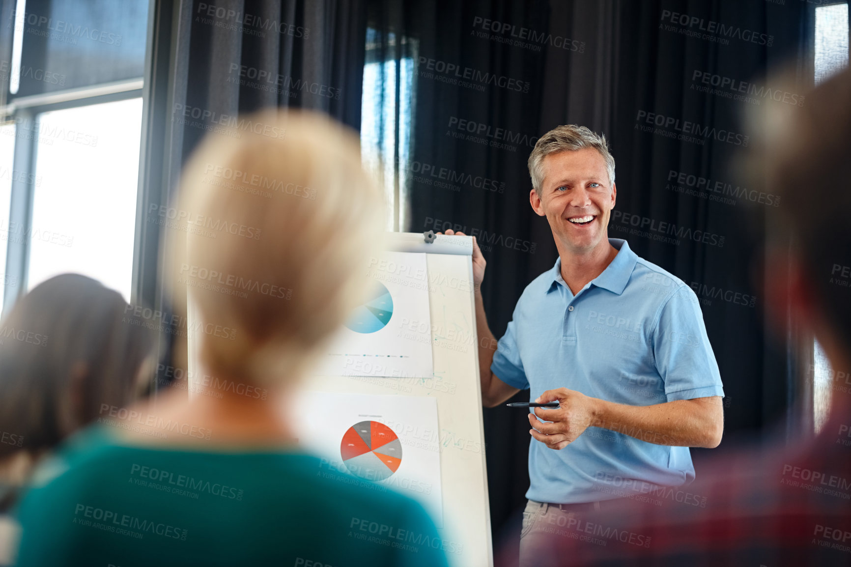 Buy stock photo Shot of a mature man doing a presentation for his colleagues