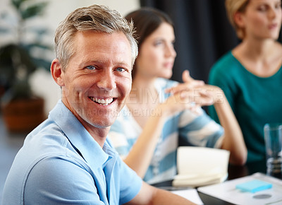 Buy stock photo Portrait of a mature man in a conference room with his colleagues in the background