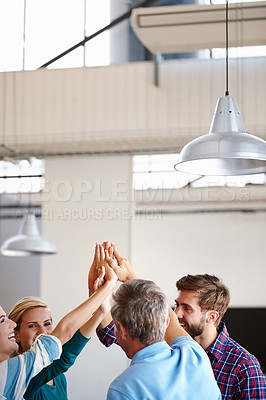 Buy stock photo Shot of a group of coworkers high-fiving in an office
