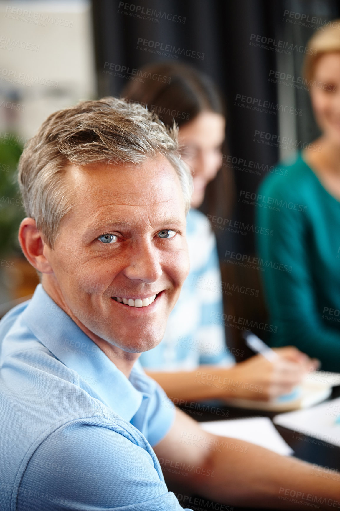 Buy stock photo Portrait of a mature man in a conference room with his colleagues in the background