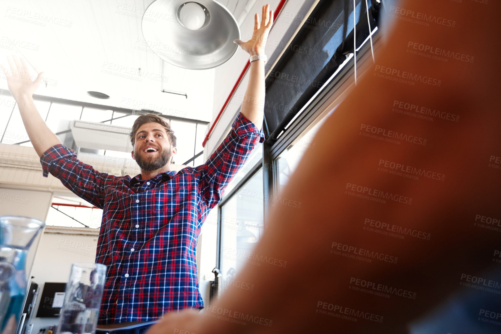 Buy stock photo Shot of a man raising his arms in victory at the office