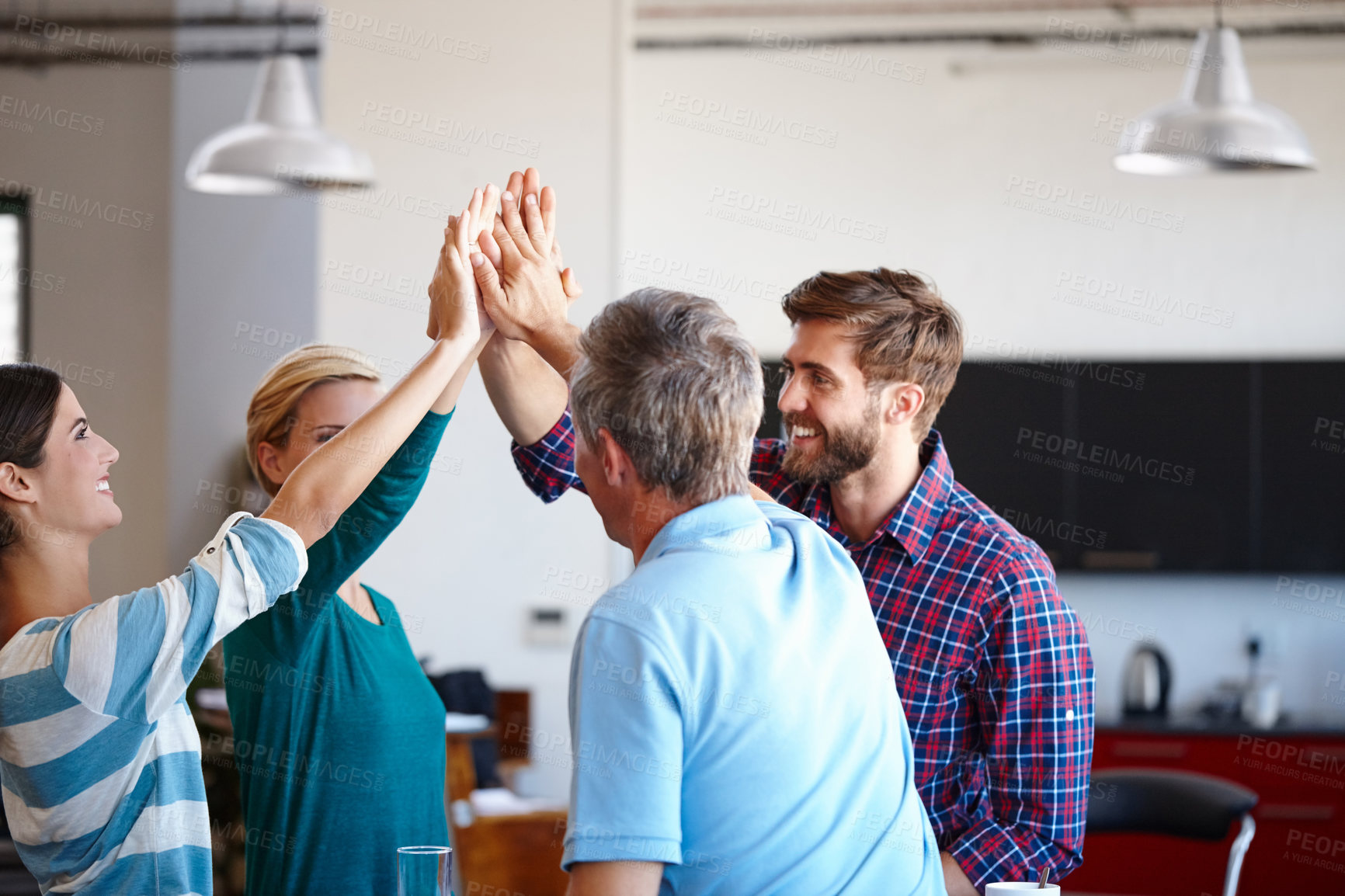 Buy stock photo Shot of a group of coworkers high-fiving in an office