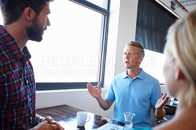 Buy stock photo Shot of a group of colleagues having a brainstorming sesion