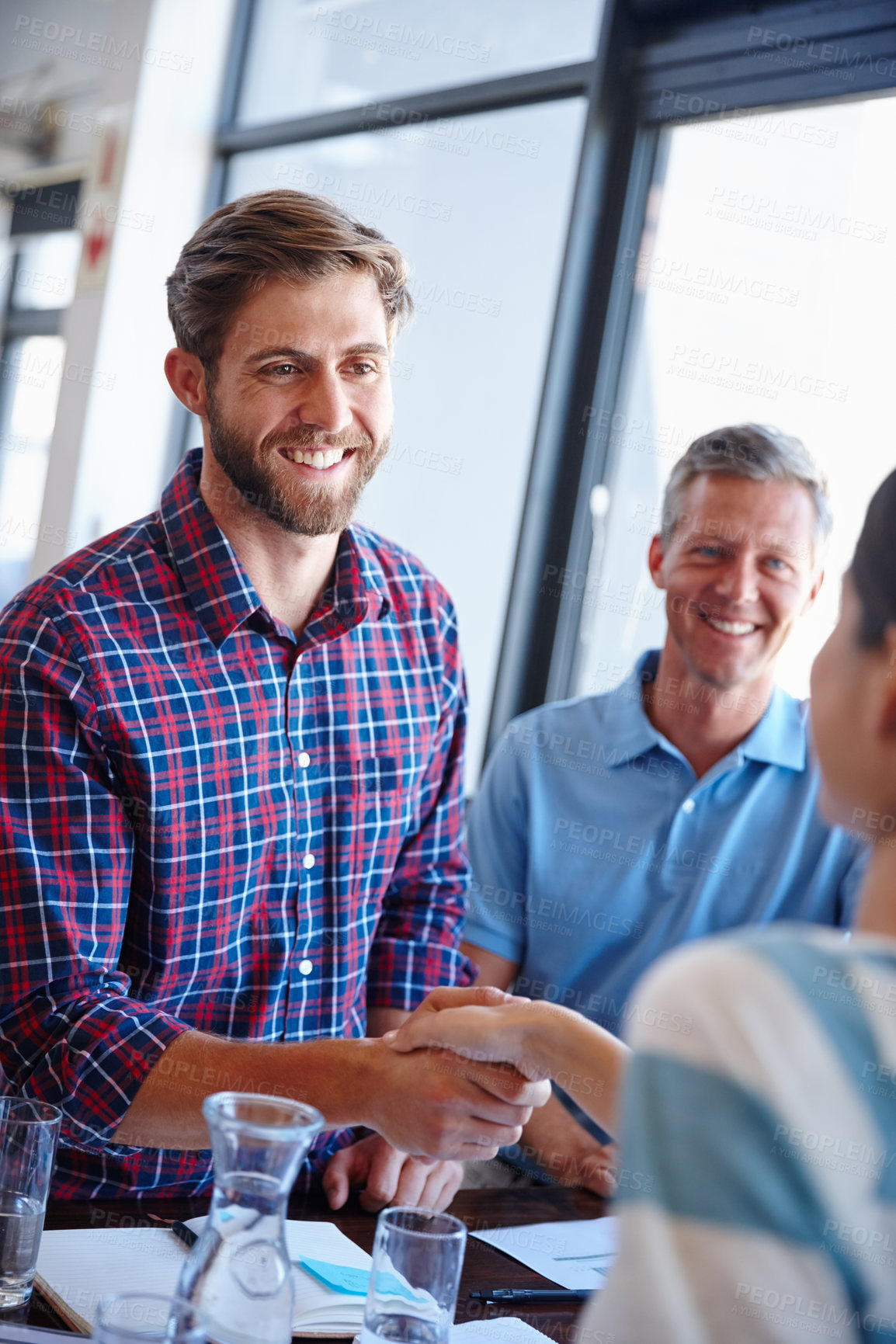 Buy stock photo Shot of coworkers shaking hands in an office