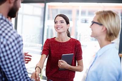 Buy stock photo Cropped shot of two coworkers shaking hands