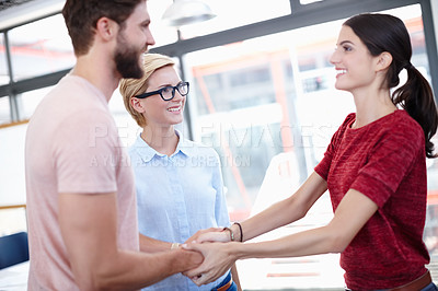 Buy stock photo Cropped shot of two coworkers shaking hands