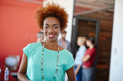 Buy stock photo Portrait of a young designer with her colleagues standing in the background
