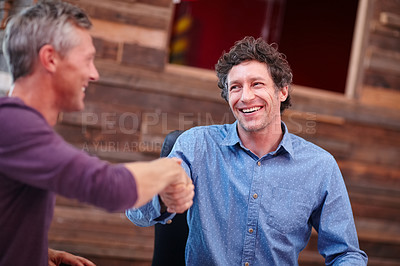 Buy stock photo Cropped shot of two coworkers shaking hands