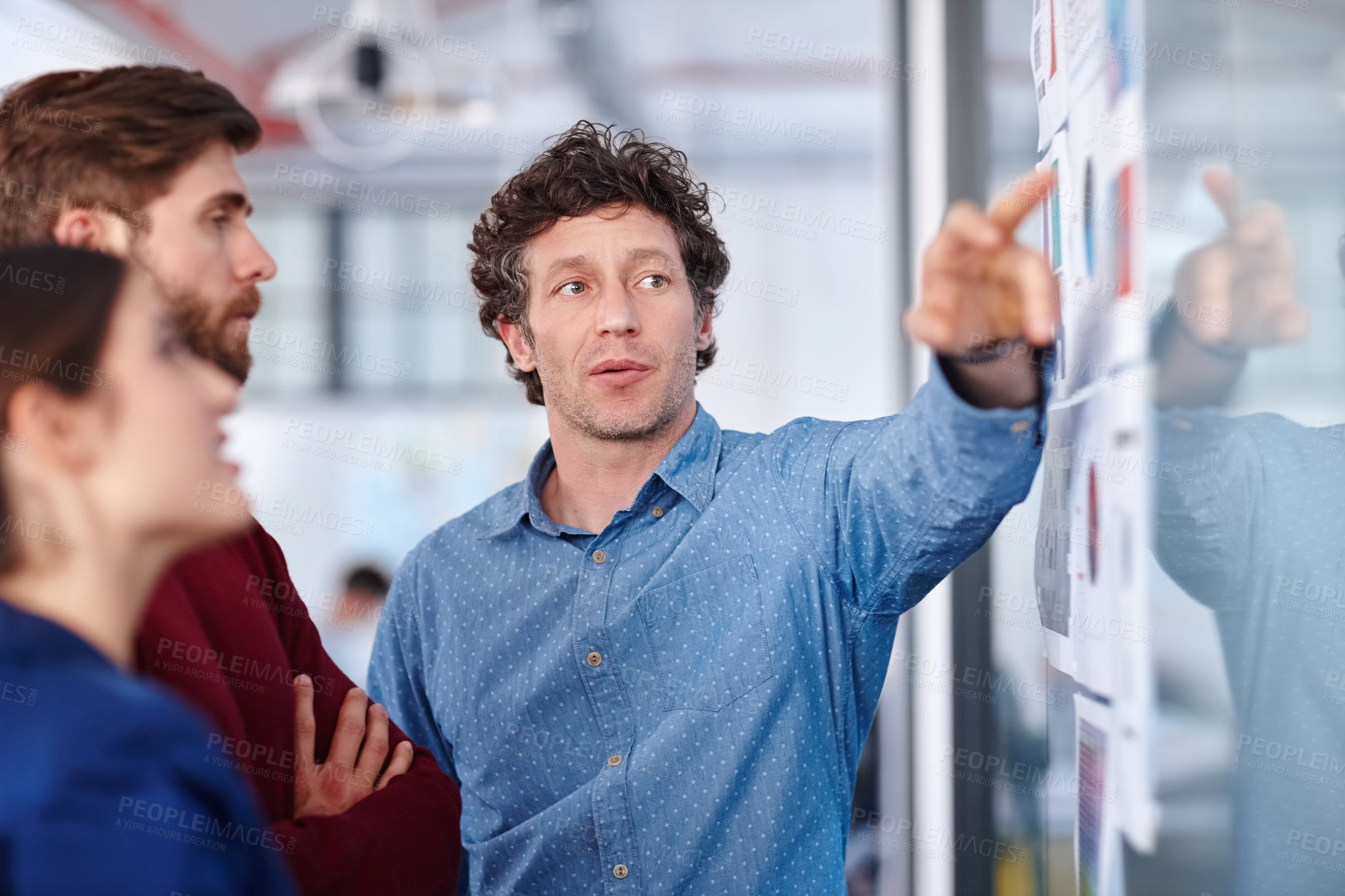 Buy stock photo Shot of a group of creative professionals working together on designs