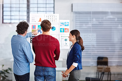 Buy stock photo Rearview shot of creative professionals working together on designs