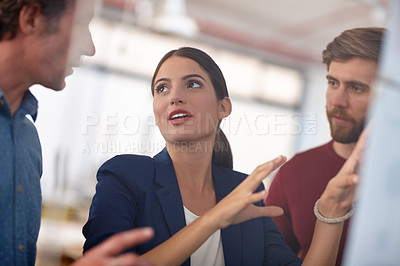 Buy stock photo Shot of a group of creative professionals working together on designs