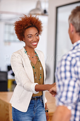 Buy stock photo Cropped shot of an attractive young businesswoman shaking a colleague's hand