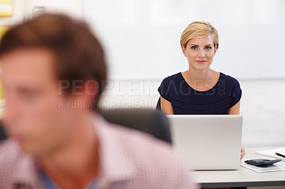 Buy stock photo Cropped portrait an attractive young businesswoman working on her laptop