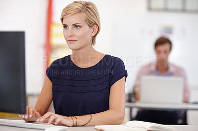 Buy stock photo Cropped shot an attractive young businesswoman working on her laptop