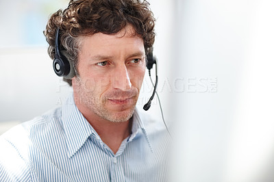 Buy stock photo Cropped shot of a handsome call center operator in the office