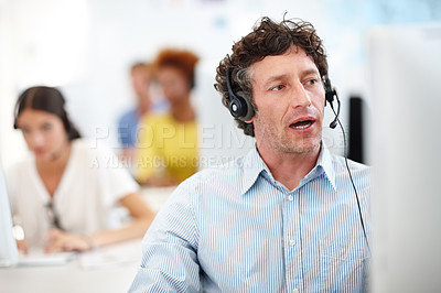Buy stock photo Cropped shot of a handsome call center operator in the office