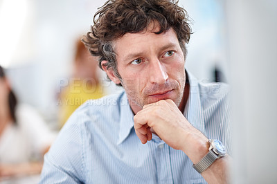 Buy stock photo Cropped shot of a handsome businessman working on his pc