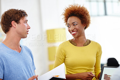 Buy stock photo Cropped shot of two young colleagues working in the office