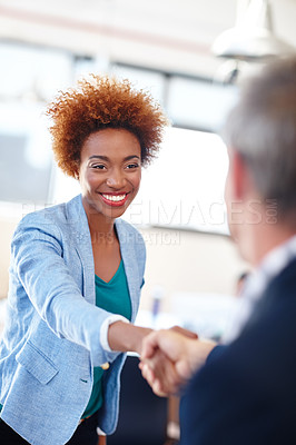Buy stock photo A mature team leader shaking hands with a colleague