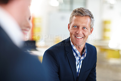 Buy stock photo Cropped shot of a mature businessman talking to his colleagues in the office