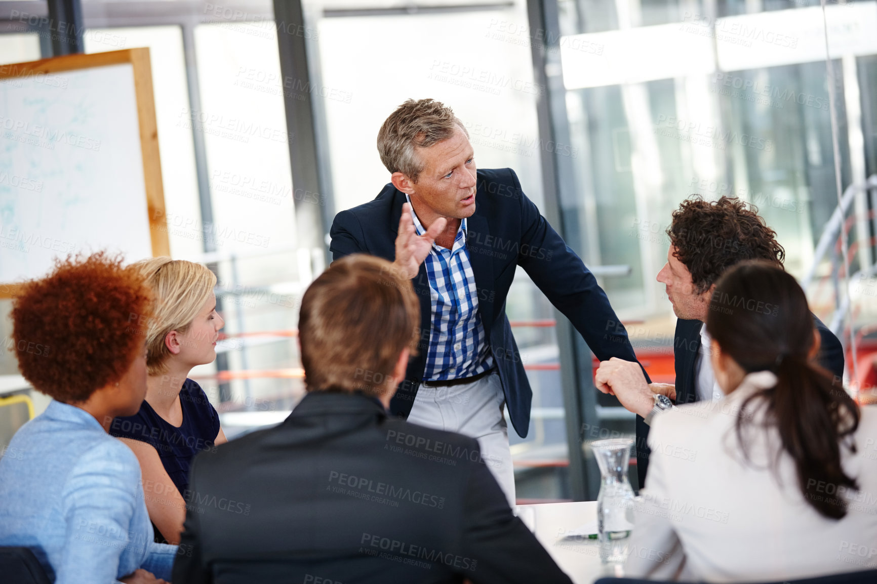 Buy stock photo Cropped shot of a group of business professionals in an office meeting